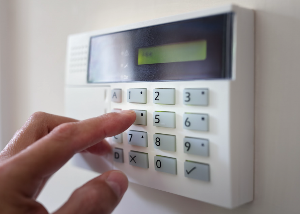 man switching on wireless fire alarm system