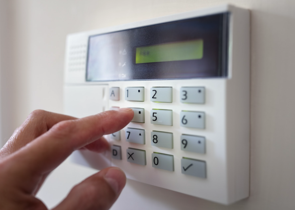 man switching on wireless fire alarm system